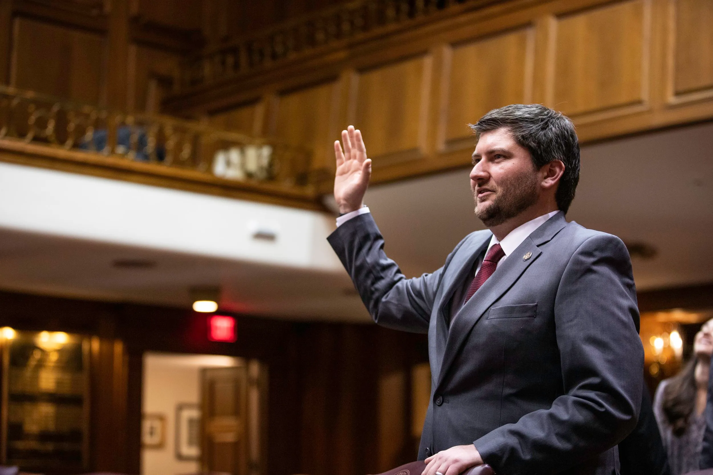 Kyle Pierce raising his right hand as he takes the oath of office in the Indiana House chamber